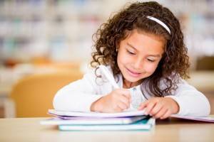 Young girl writing at desk
