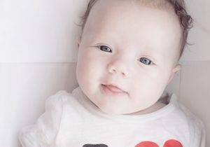 close up of a baby laying in a crib