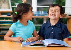 two students reading at a desk