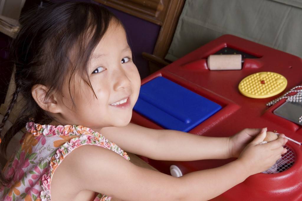 girl playing with interactive table