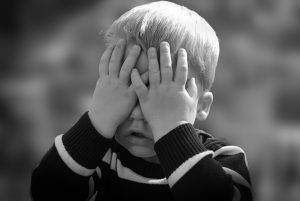 child covering their eyes to regulate emotions