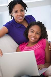 Mom-and-daughter-with-computer-200×300 (1) Child and adult looking at a laptop