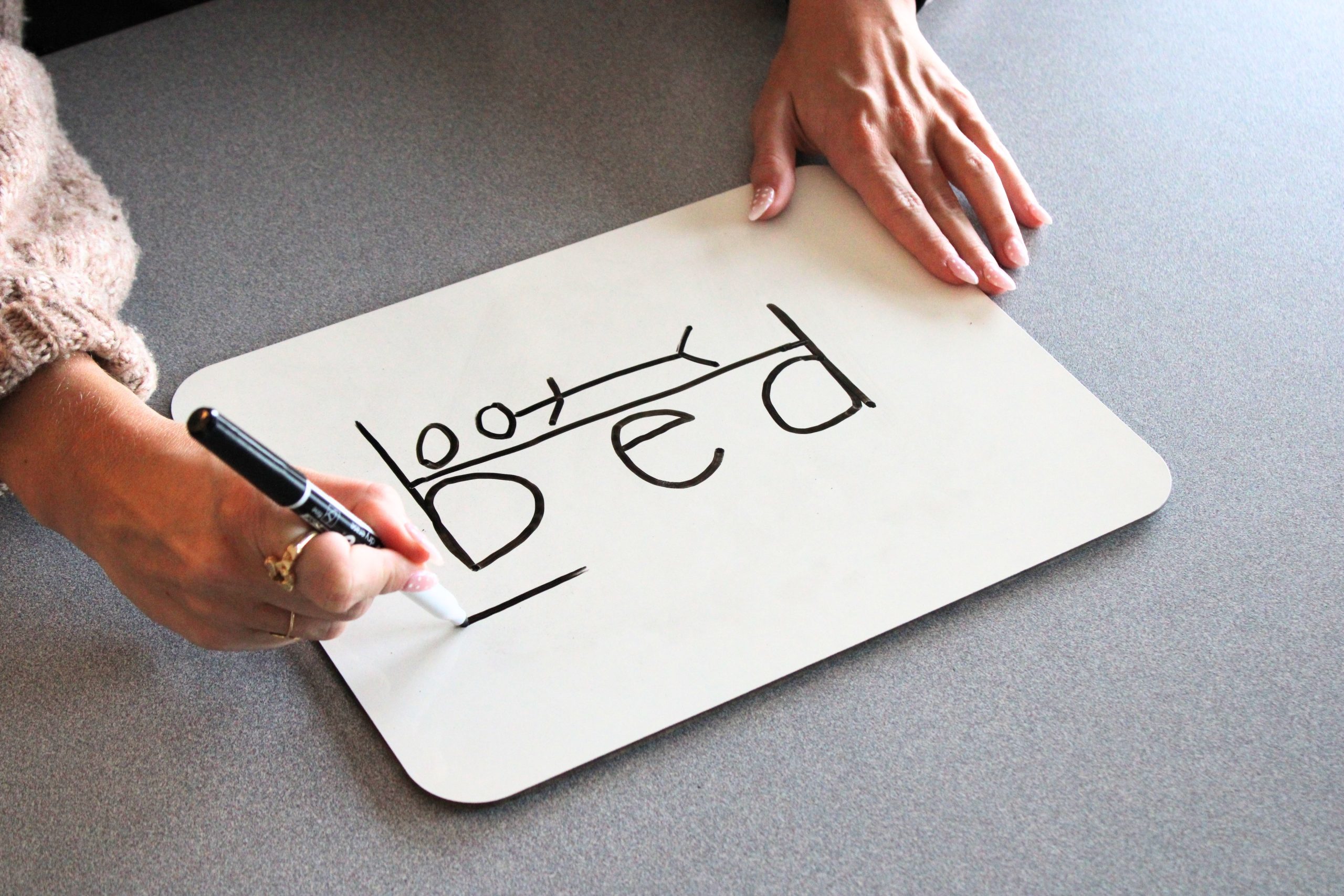 b-d-letter-reversal-bed-trick-whiteboard.jpg Hand drawing the "bed" trick on a whiteboard, showing how the letters "b" and "d" form the headboard and footboard of a bed