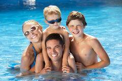 family having fun in a swimming pool