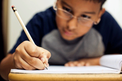boy writing in notebook