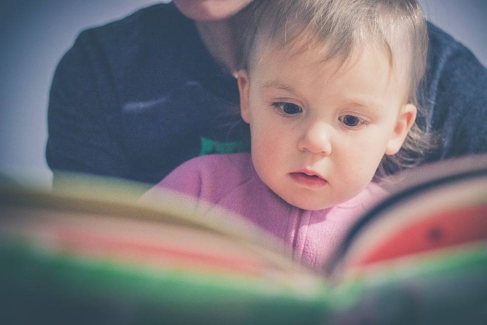 young child looking at book