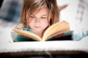 girl reading in bed