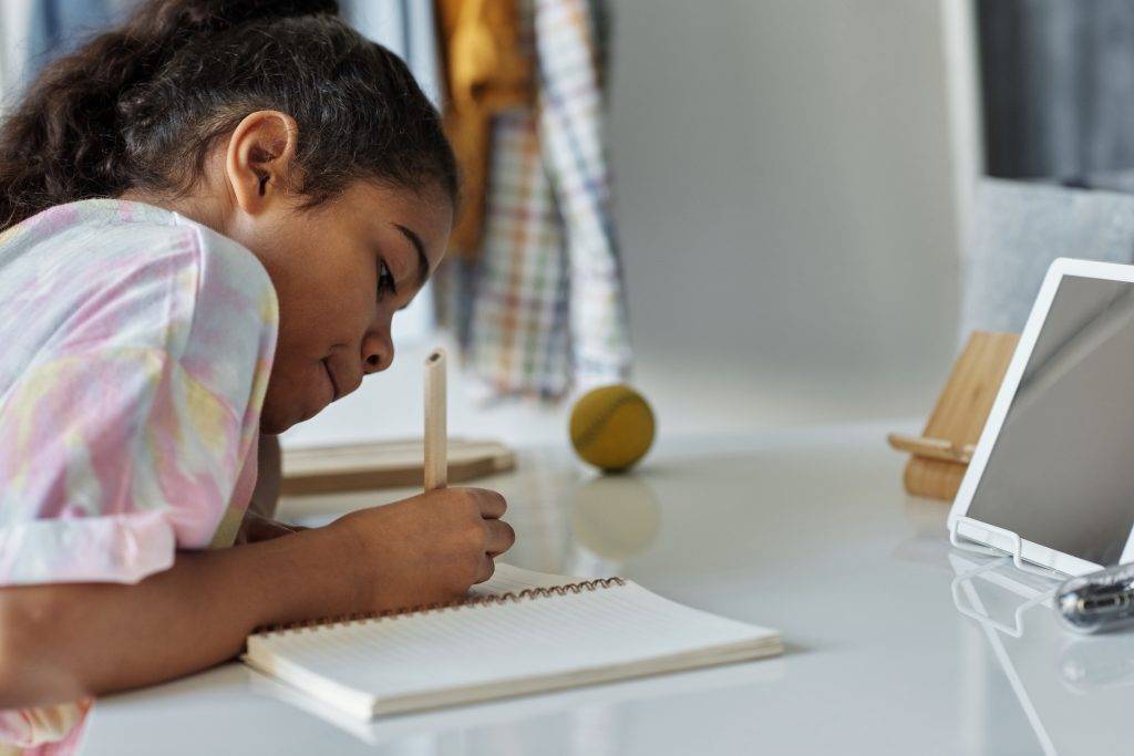 photo-of-girl-writing-on-white-paper-4143794-1-1024×683 (1) Student writing in notebook at desk