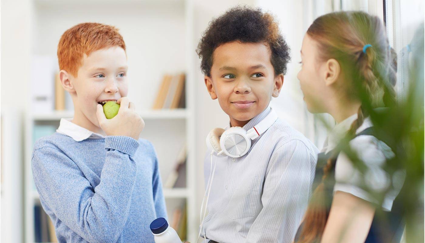 three children talking in a group