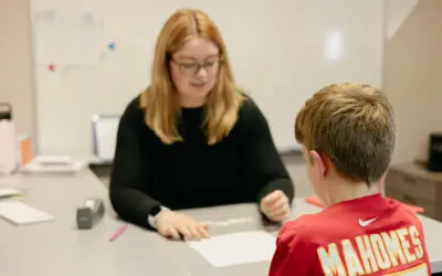 Student and teacher working at desk