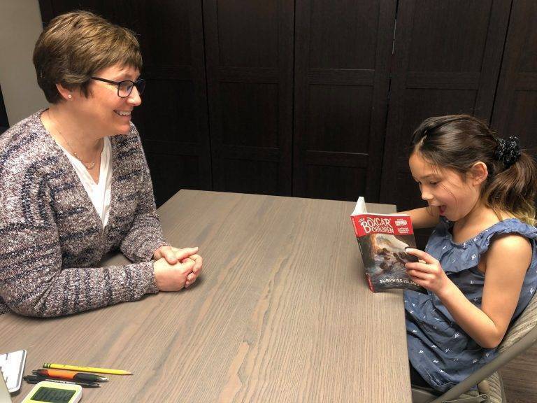 Choose a Book speech pathologist assisting student in reading