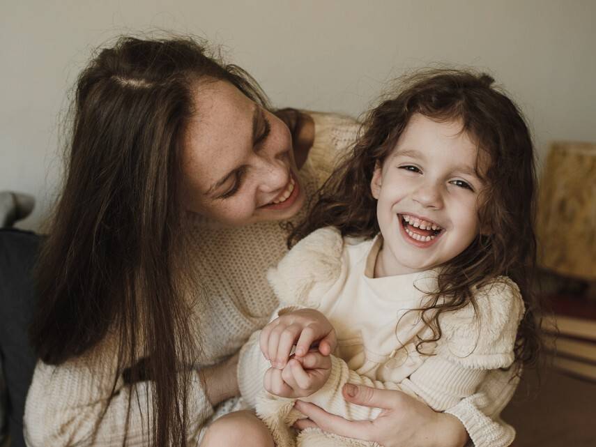 Adult and child laughing