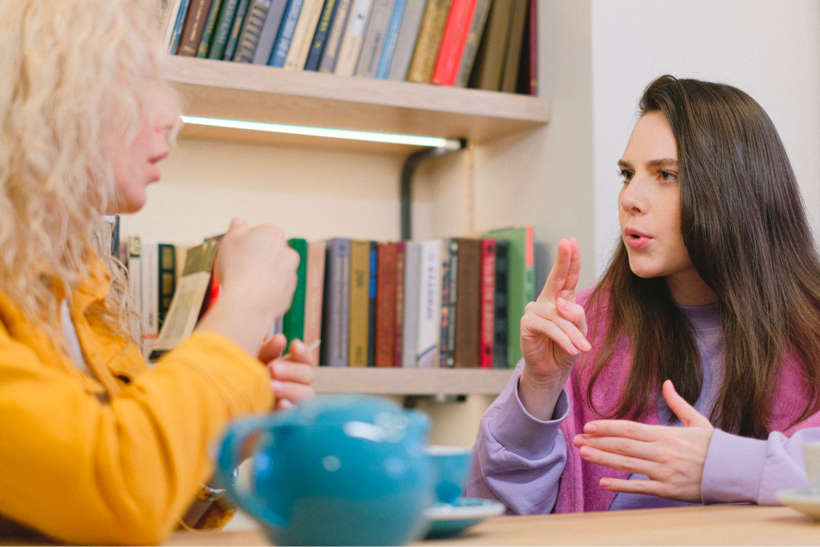 Two adults using sign language to communicate