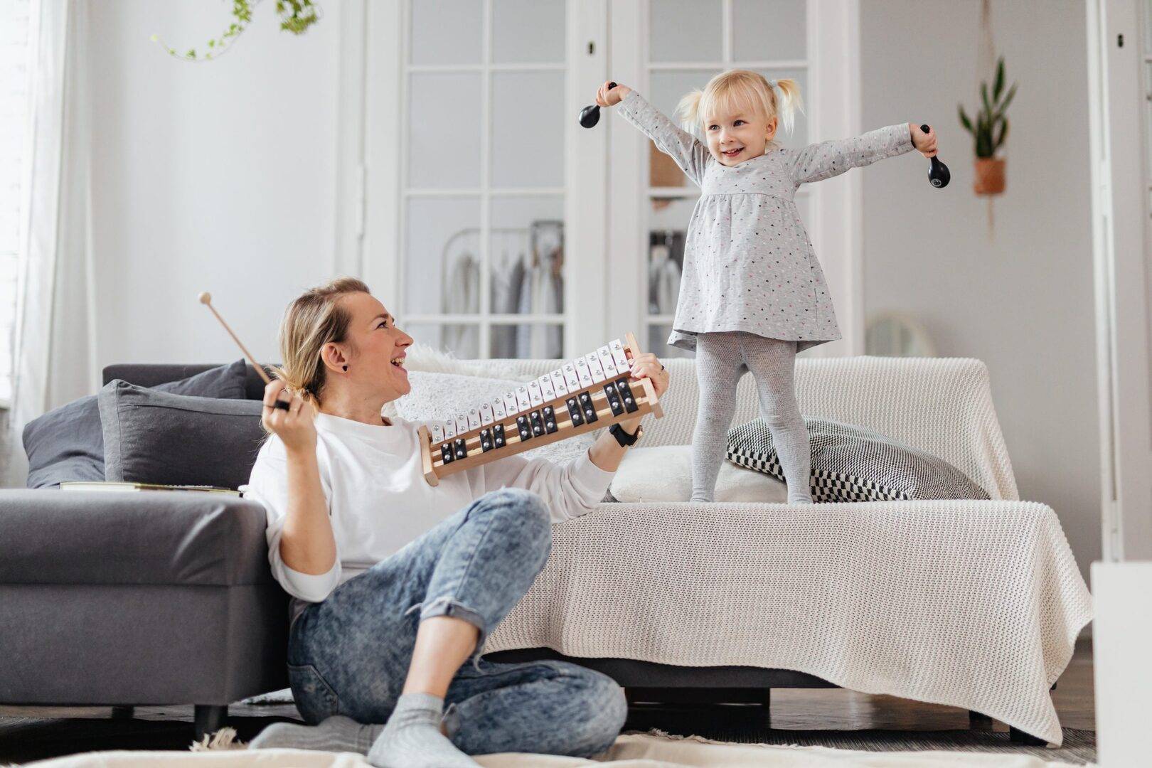 Mom and child playing with toys in living room