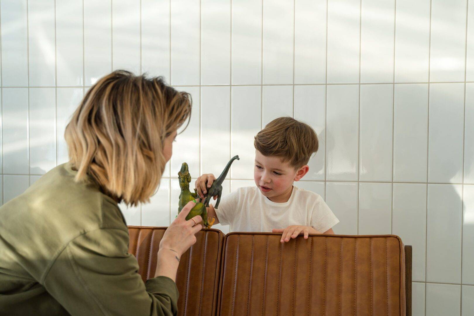 mom and son playing with dinosaurs