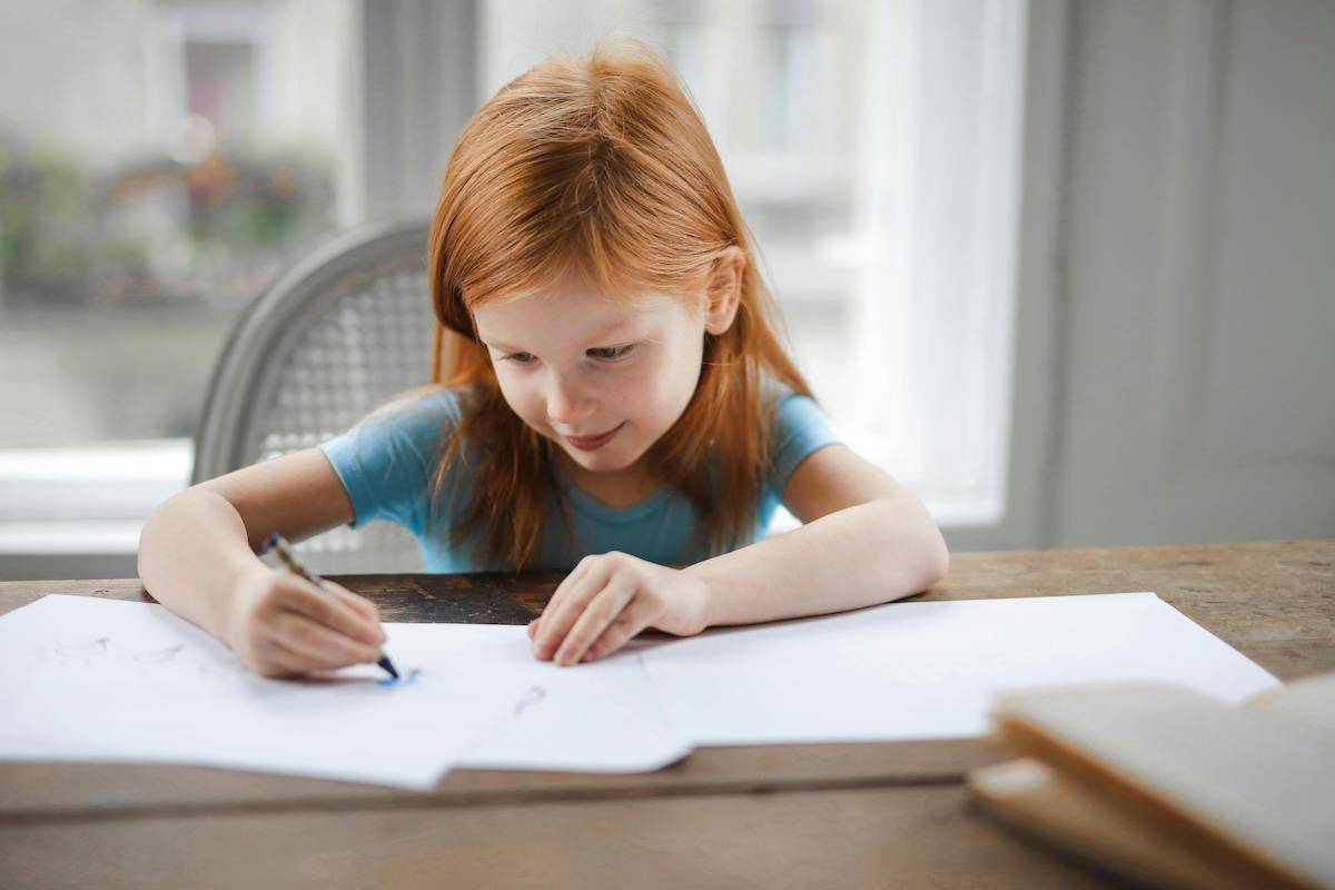 Young girl writing at a desk