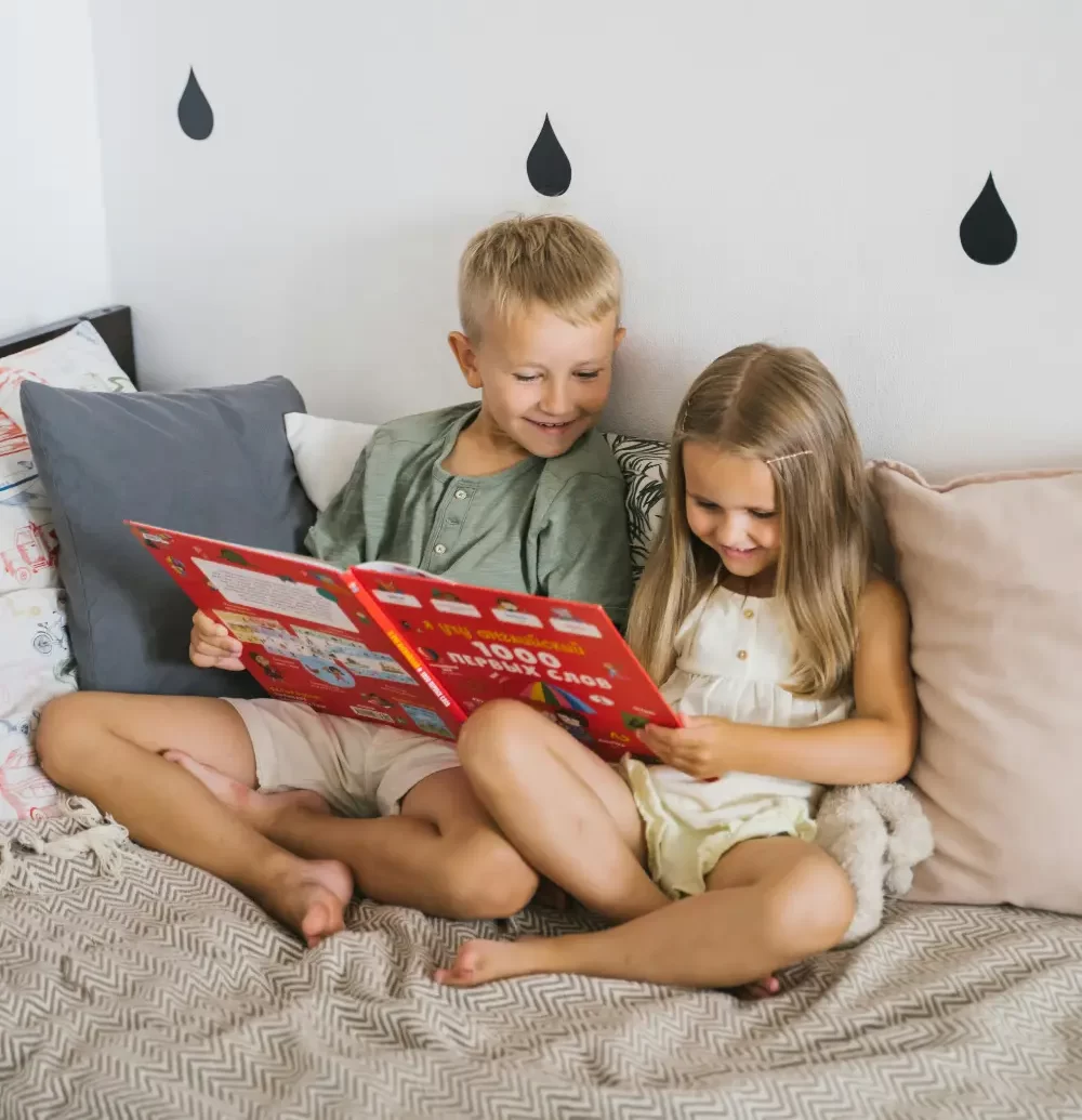 brother and sister reading together