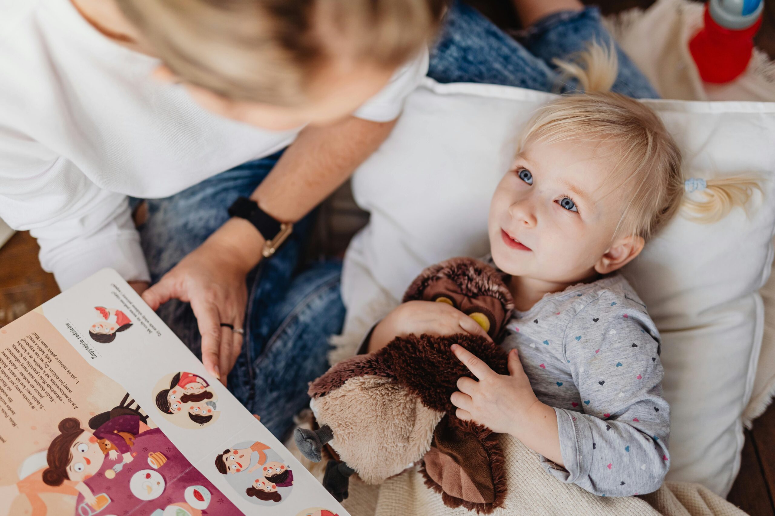 woman reads to a young preschool girl