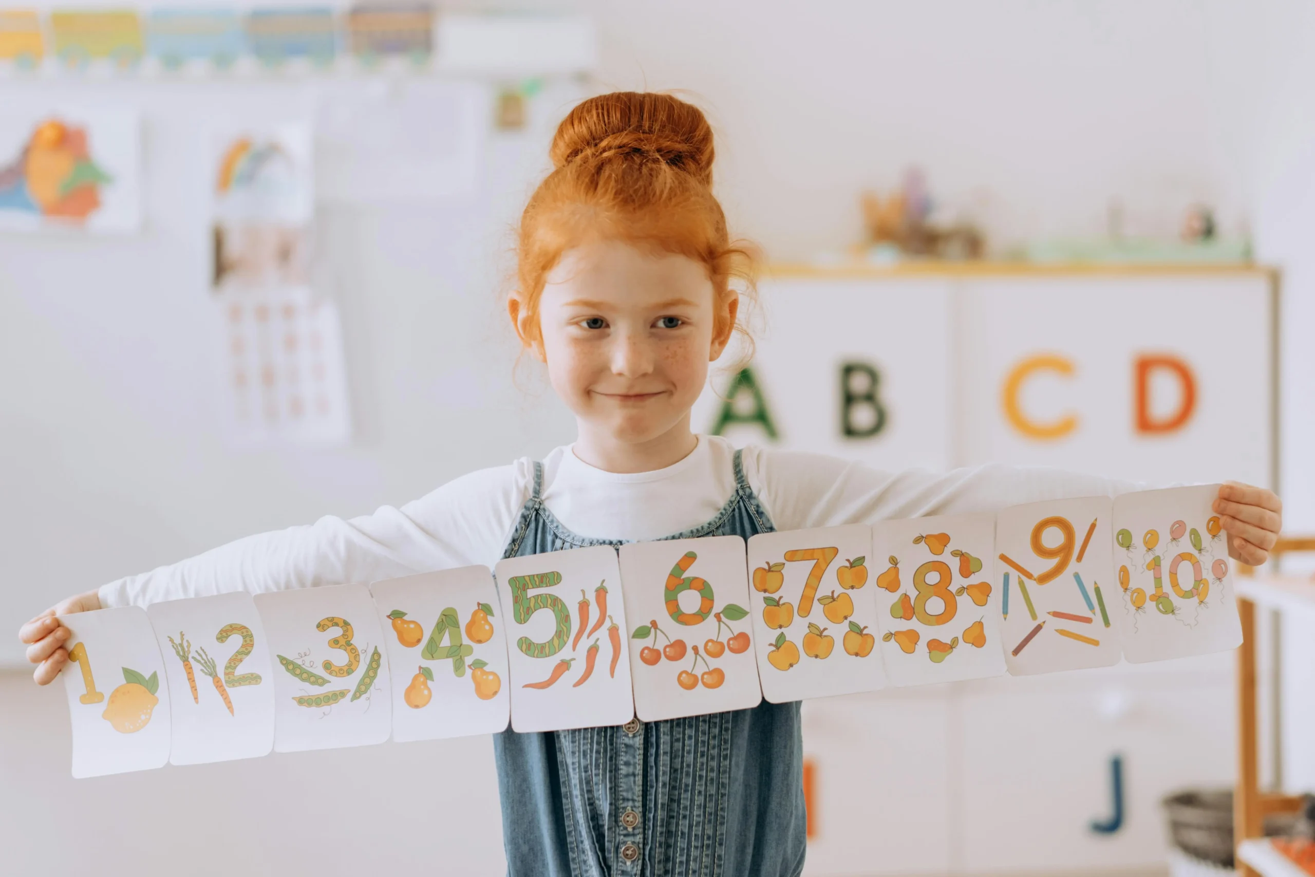 Number Sense young redhead girl holds numbered banner