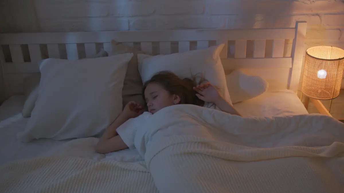 young girl sleeps in bed