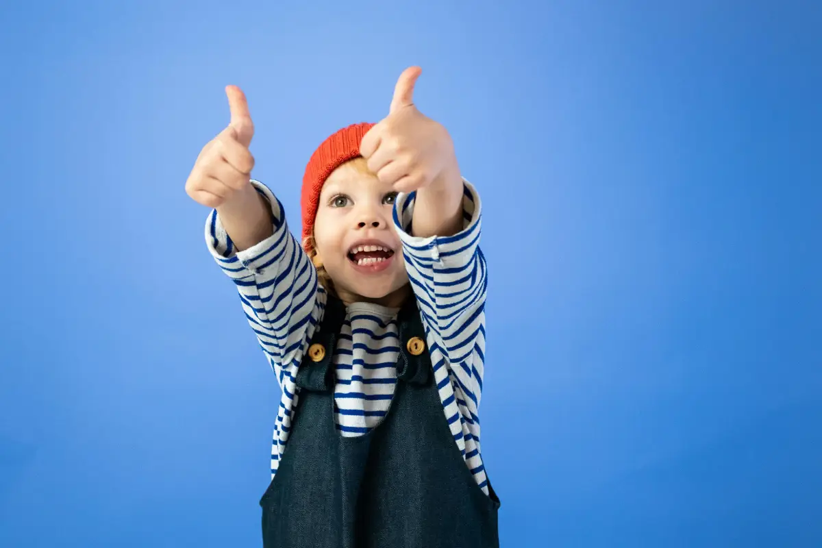 Toddler thumbs up boy gives two thumbs up