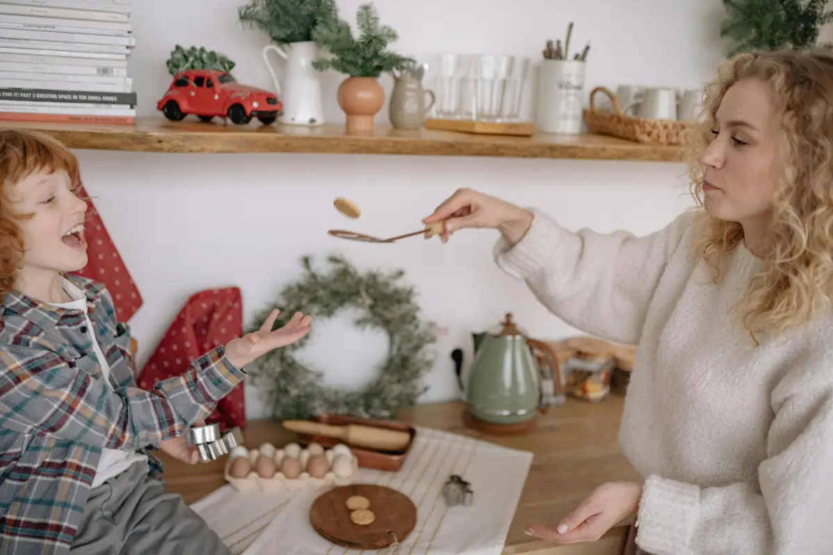 child plays with food with mother