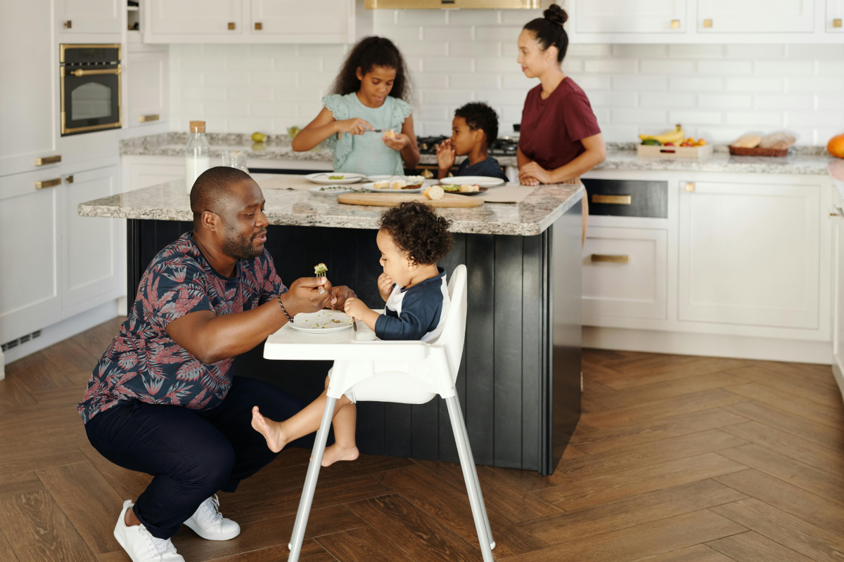 family sits around kitchen during meal time