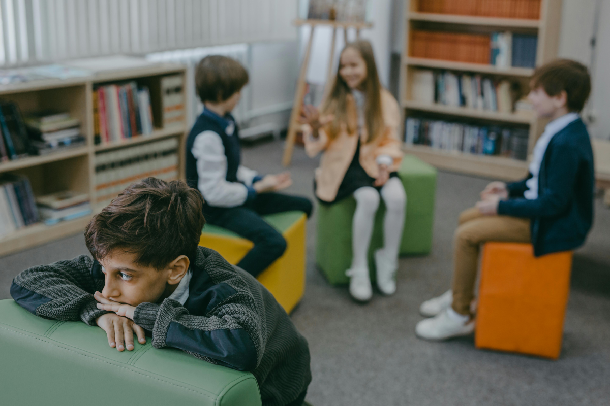anxious child sits with peers in classroom